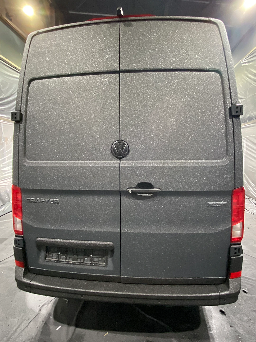 VW Crafter в покрасочной камере после покрытия защитой Line-X